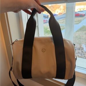 Lululemon mini barrel Cream and Black Crossbody Bag